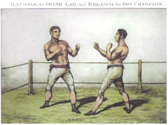 Belasco is upon the right with sideburns. Randall is on the left with lighter hair. They both wear nothing but knickerbocker breeches and sashes girdling the waist.