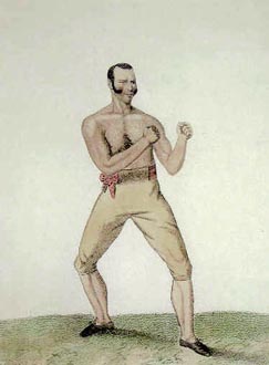 Dutch Sam stands alone, his fists held up. He wears yellow knickerbocker breeches and a pair of long mutton chop sideburns.
